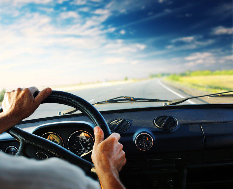 man driving car on open road